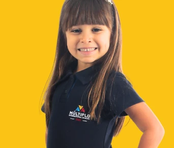 Aluna do Múltiplo International School de uniforme, sorrindo, sobre fundo amarelo